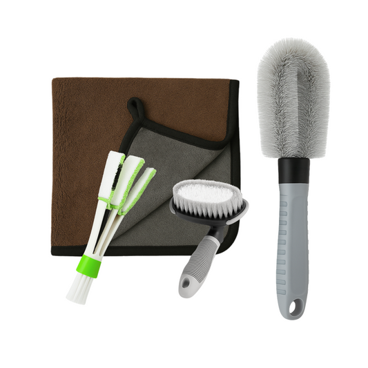 Set of car cleaning tools including brushes and a towel on a white background