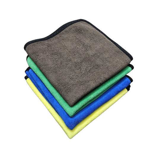 Stack of four microfiber cloths in gray, green, blue, and yellow on a white background