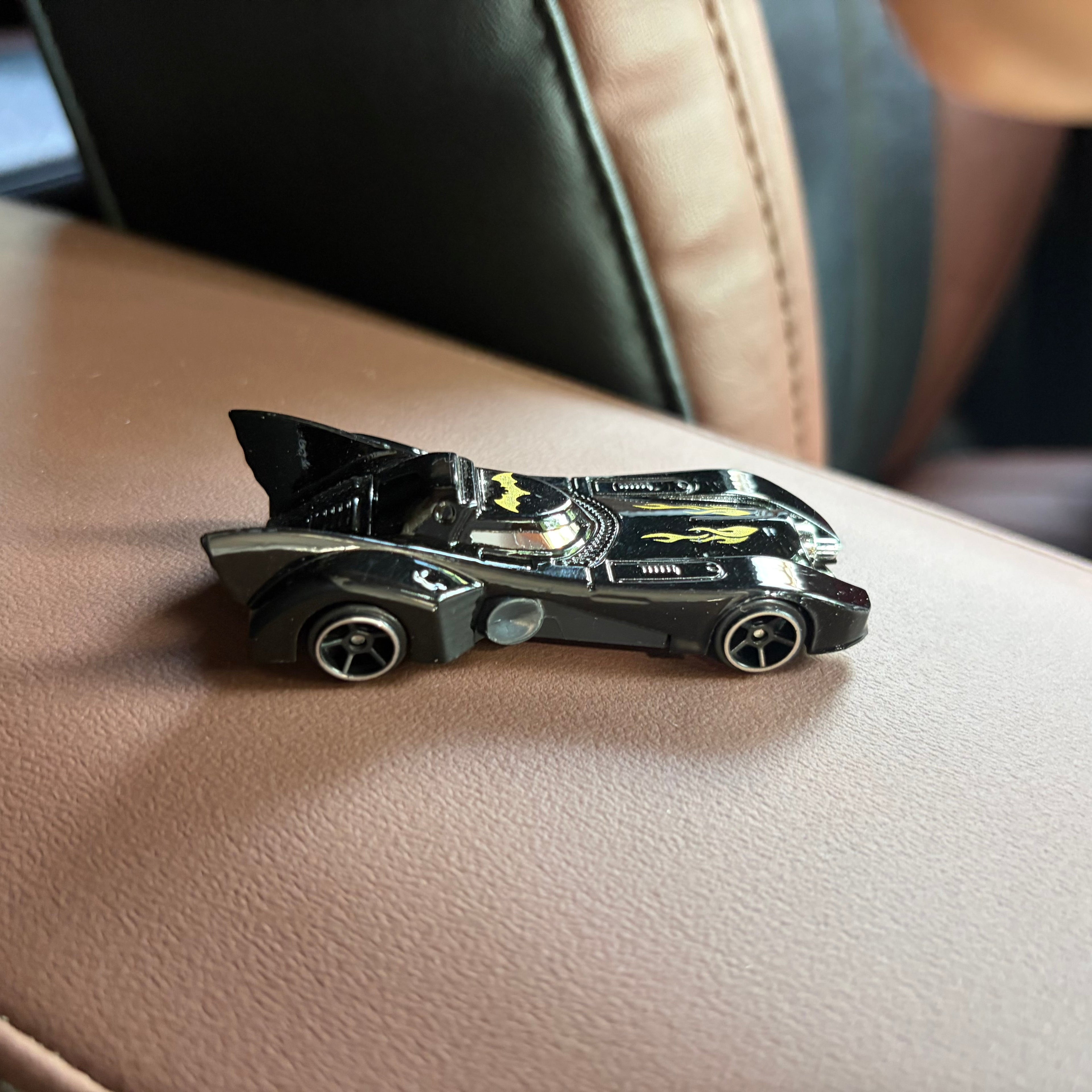 All 6 Batman Batmobile die-cast cars displayed on car dashboard
