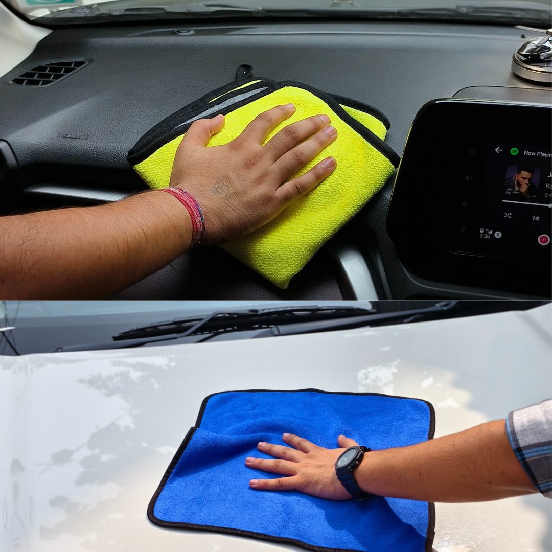 Person cleaning car interior with a yellow microfiber cloth and applying a blue towel on car surface.