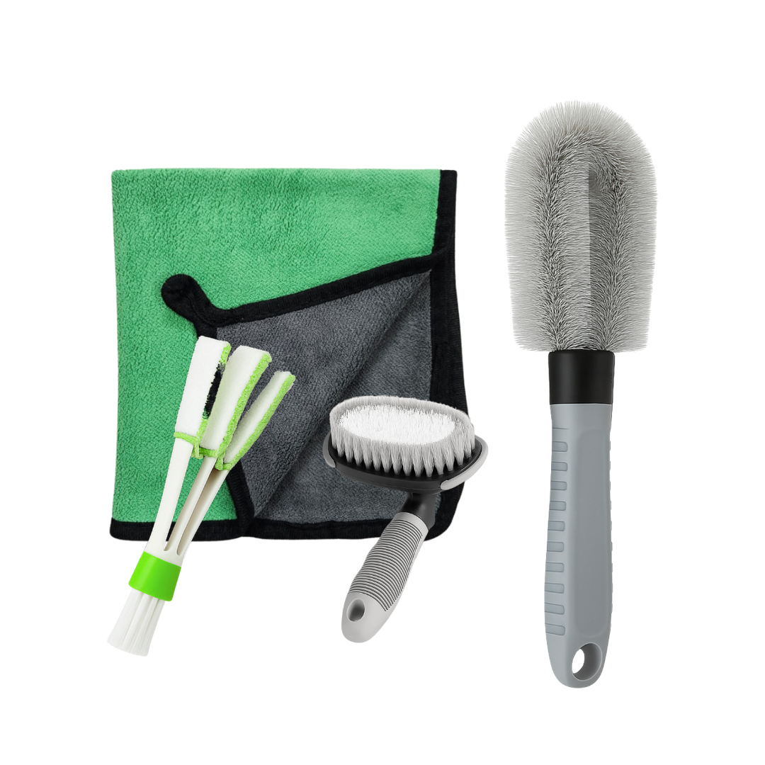 Set of car cleaning tools including brushes and a towel on a white background