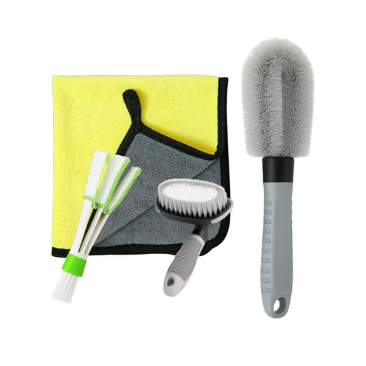 Car cleaning tool set with brushes, scrubber, and towel on a white background