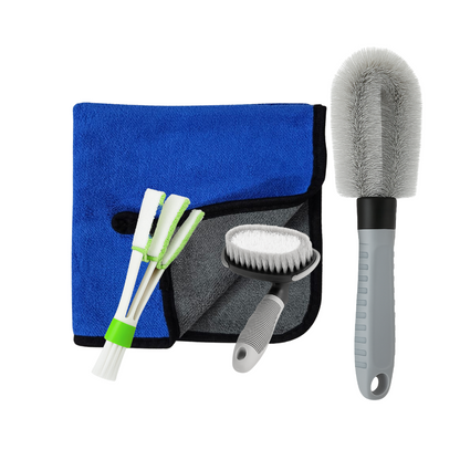 Car cleaning tool set with blue towel, brushes, and brush holder on a white background