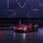 Dual-tone red and black Lamborghini Revuelto die-cast model displayed on a premium gaming desk with red lighting